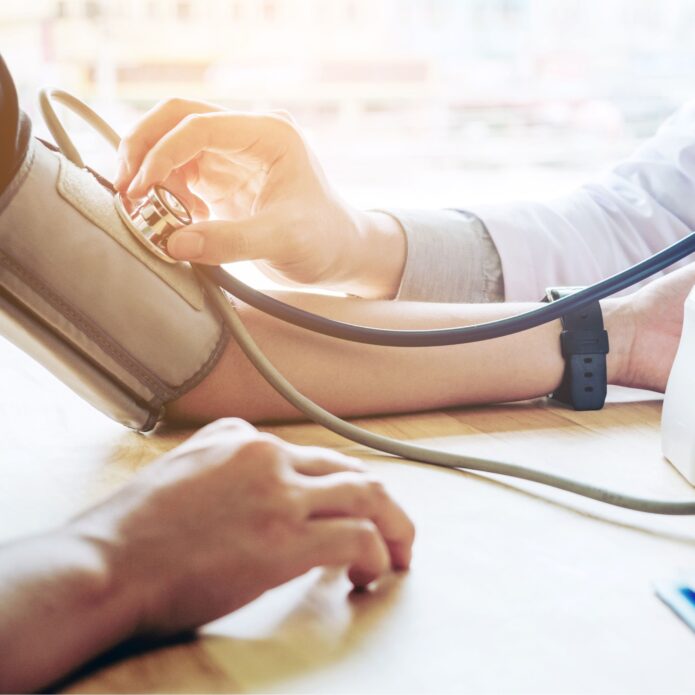 A person gets their blood pressure measured