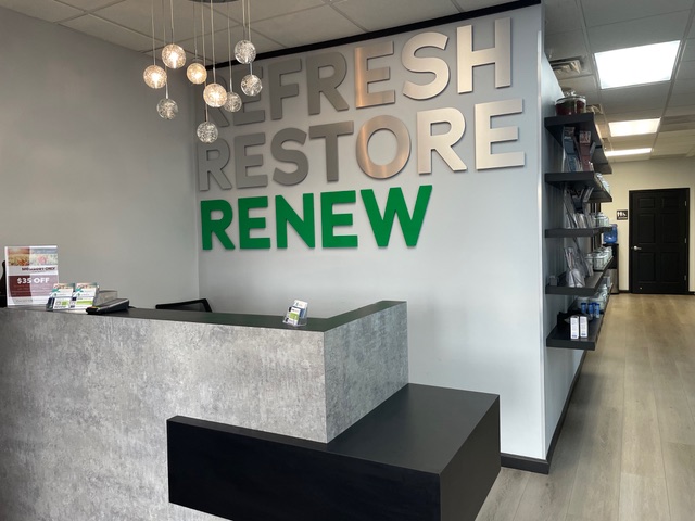 A reception area with a sign that says fresh restore renew, offering drip hydration and blood testing services.