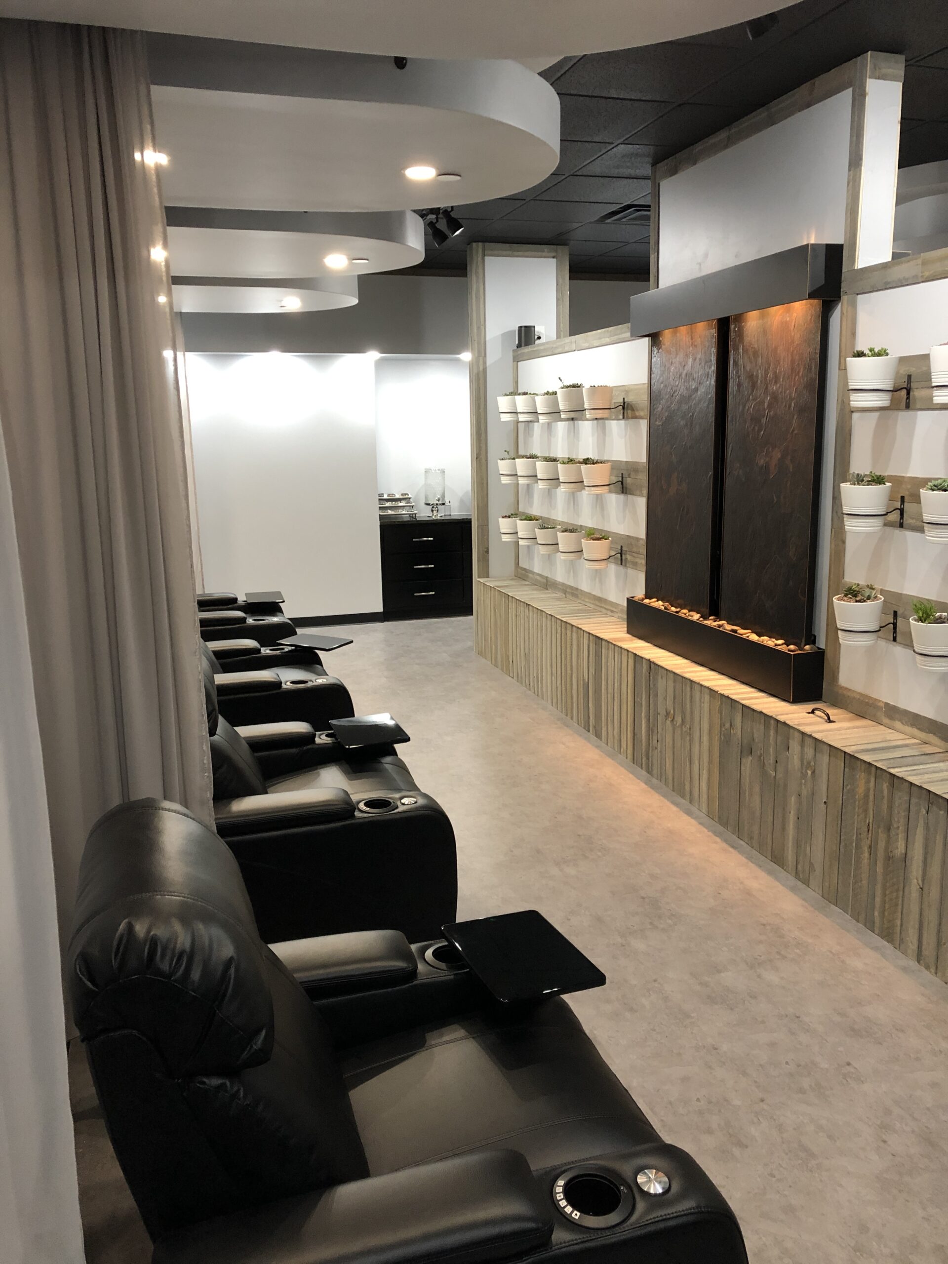 A salon offering drip hydration, iv therapy, and blood testing services, with a wall of mirrors.